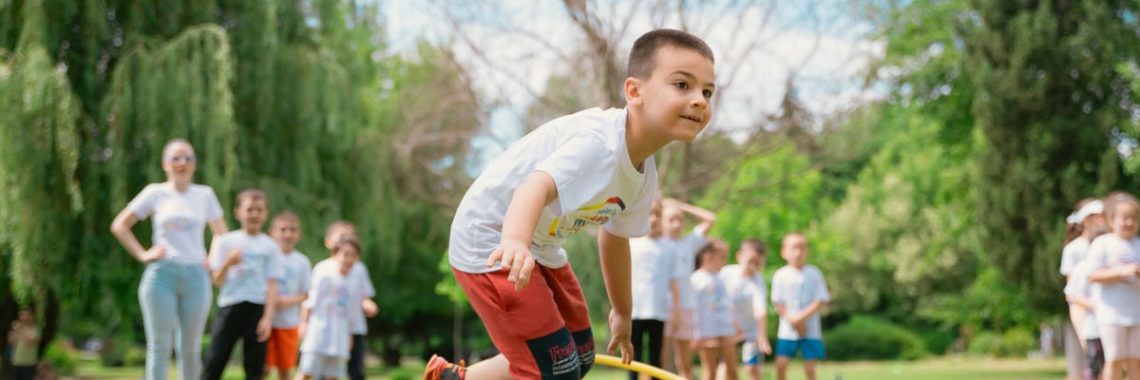 Kids enjoy outdoor fun with hula hoops in a vibrant park setting.